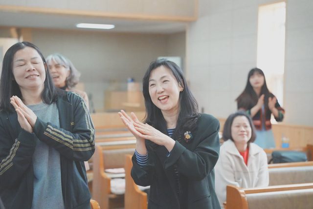 박수 치며 환히 웃는 예배 모습